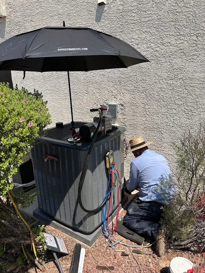 HVAC technician performing outdoor AC maintenance in Larkfield-Wikiup
